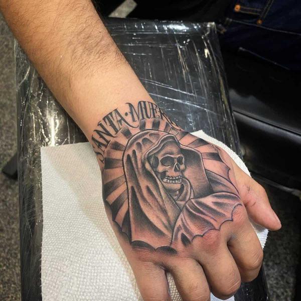 Santa Muerte hand tattoo black and grey