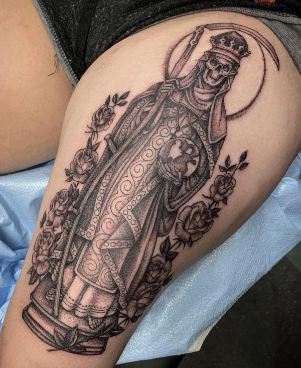 Santa Muerte holding scythe and globe tattoo on thigh