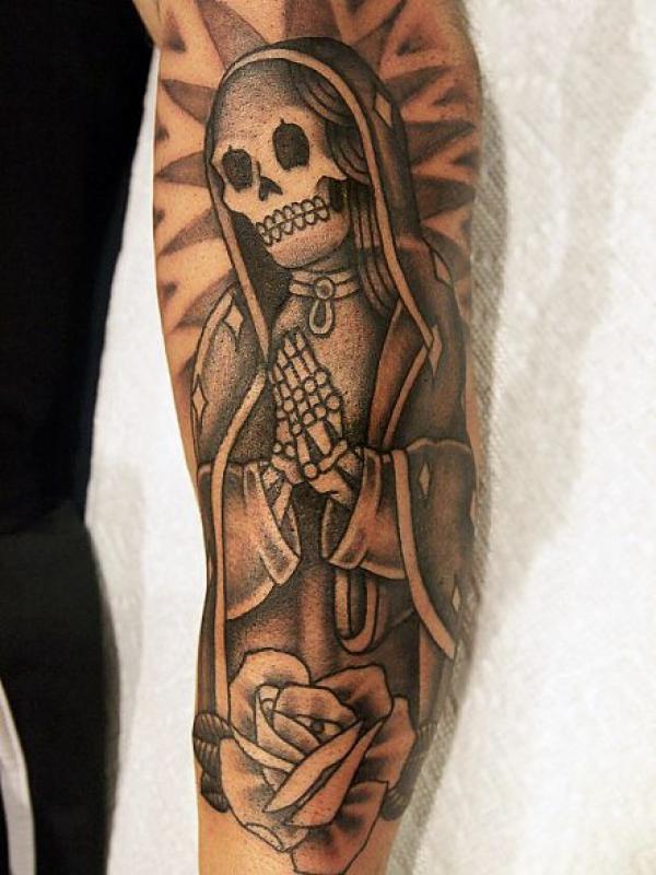 Santa Muerte with rose arm tattoo