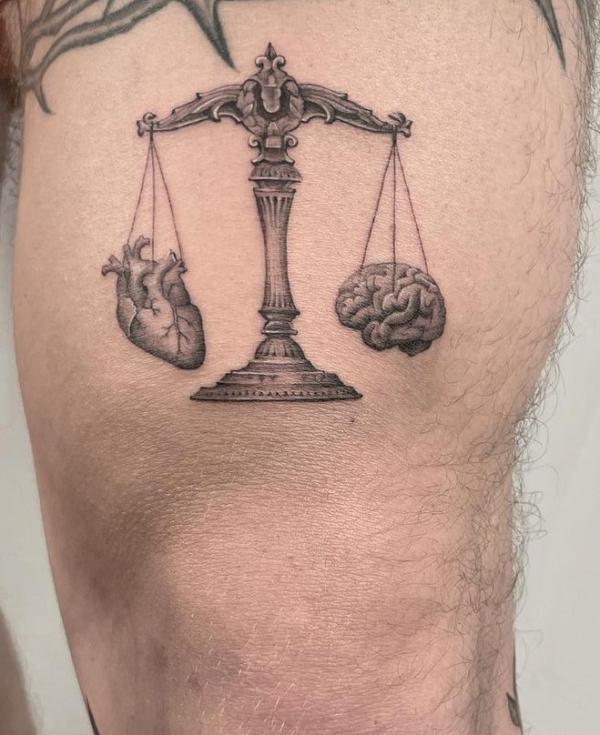 Scales of justice with heart and brain tattoo