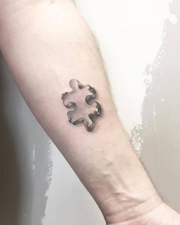 Single puzzle tattoo on forearm