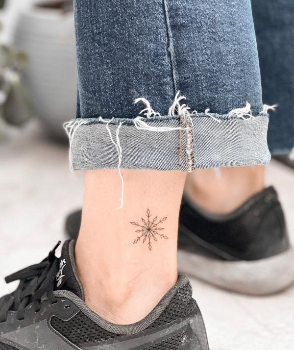 Small snowflake ankle tattoo