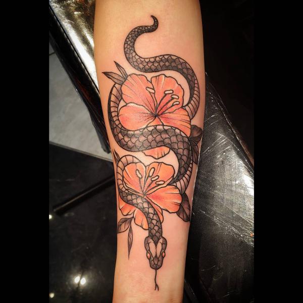 Snake and hibiscus forearm tattoo
