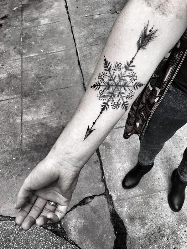Snowflake and arrow tattoo