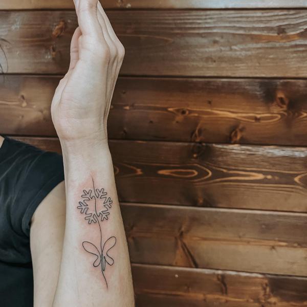 Snowflake and butterfly line work tattoo