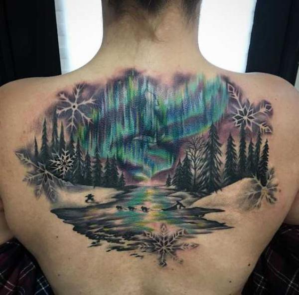 Snowflake and forest tattoo on back