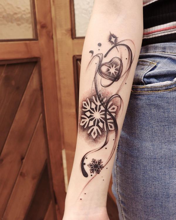 Snowflake and heart forearm tattoo