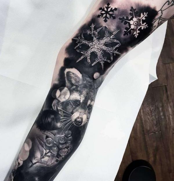 Snowflake and raccoon leg tattoo