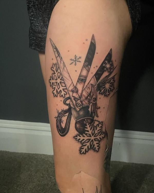 Snowflake and scissors tattoo