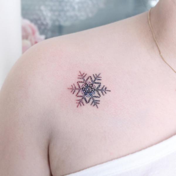 Snowflake clavicle tattoo