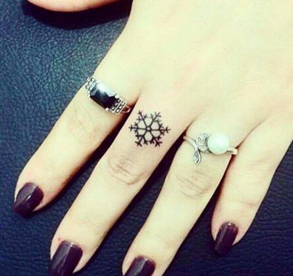 Snowflake finger tattoo