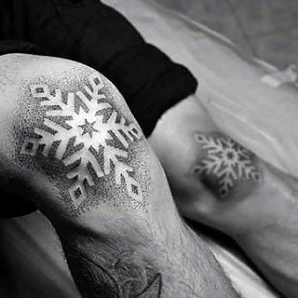Snowflake knee tattoo