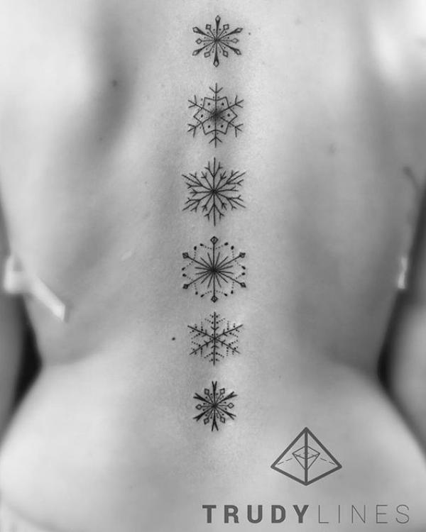 Snowflake spine tattoo
