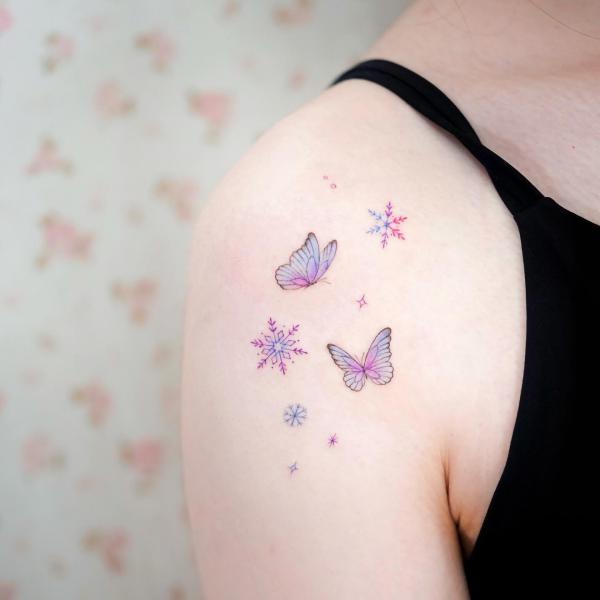 Snowflakes and butterflies shoulder tattoo