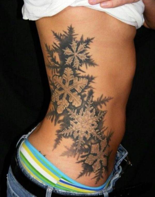 Snowflakes rib cage tattoo