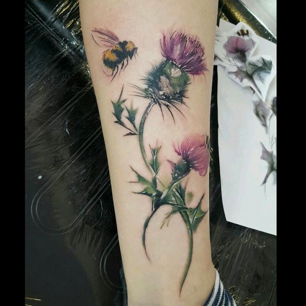 Thistle and bee lower leg tattoo