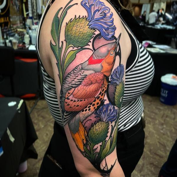 Thistle and bird half sleeve tattoo