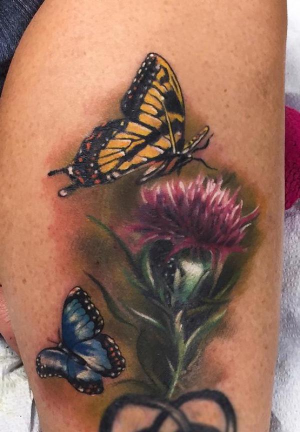 Thistle and butterfly tattoo