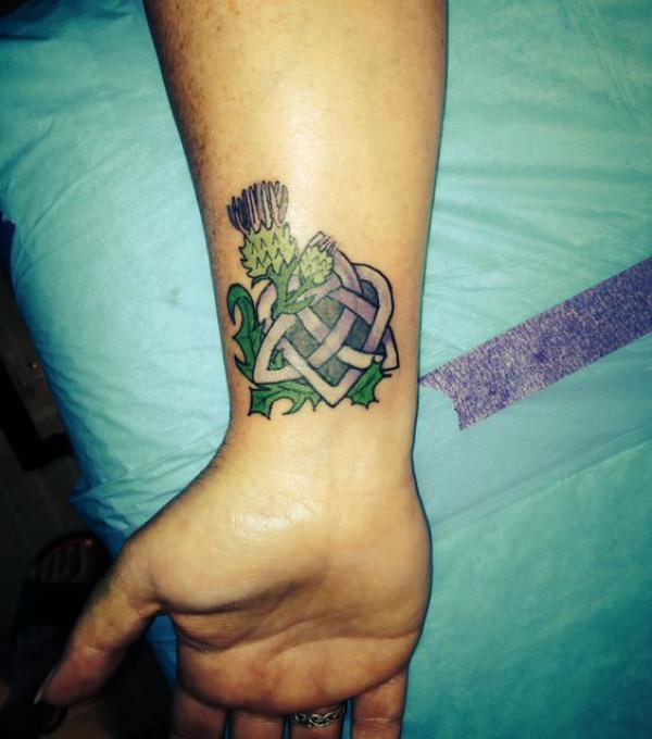 Thistle and trinity knot wrist tattoo