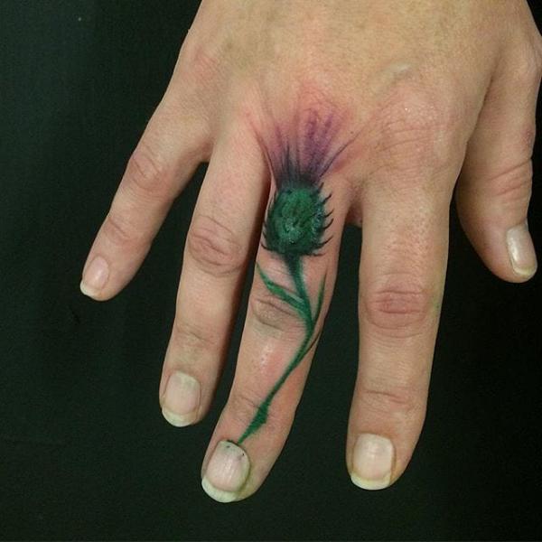 Thistle finger tattoo