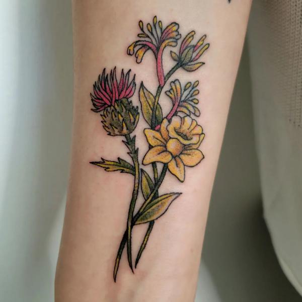Thistle honeysuckle and daffodil tattoo traditional