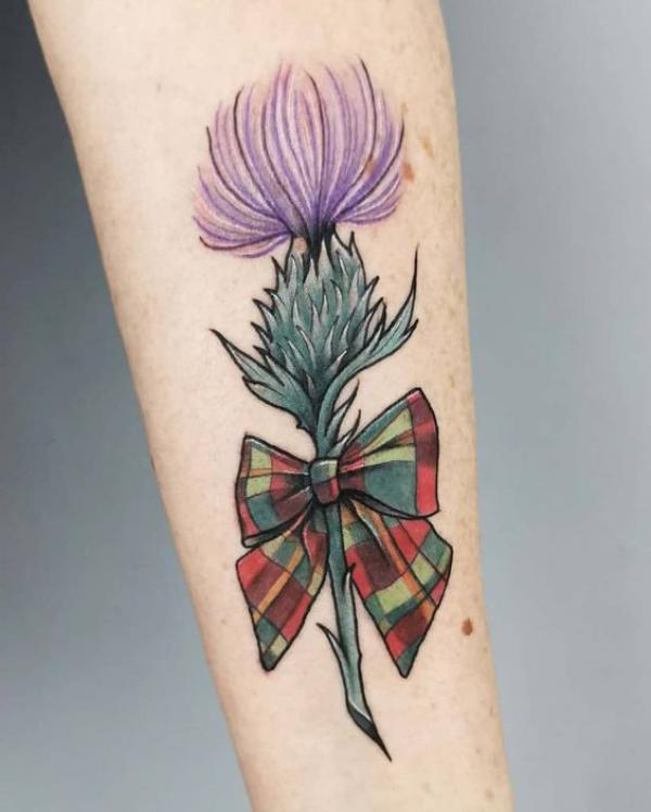 Thistle with a bow tattoo