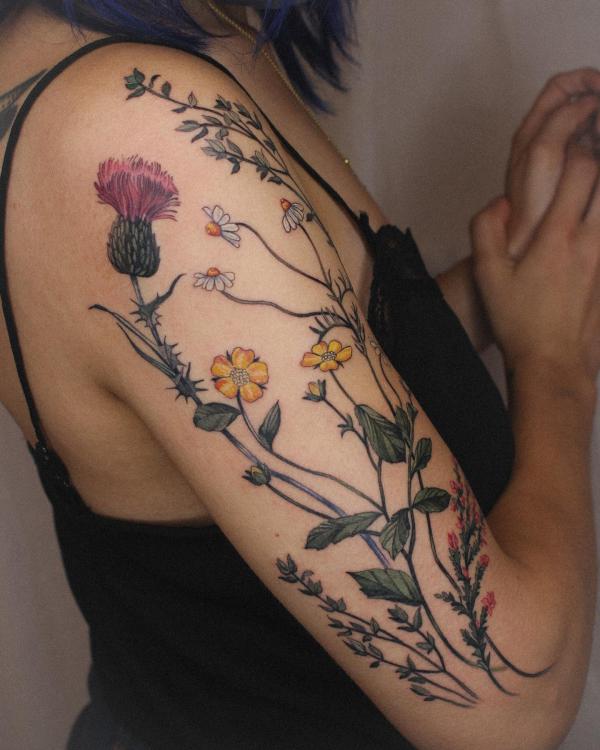 Thistle yellow poppy and daisy flower tattoo half sleeve