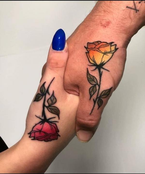 Traditional Red and yellow rose tattoo on thumbs for couples