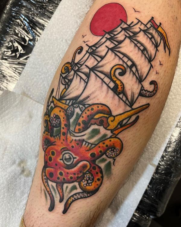 Traditional kraken and boat with sun tattoo