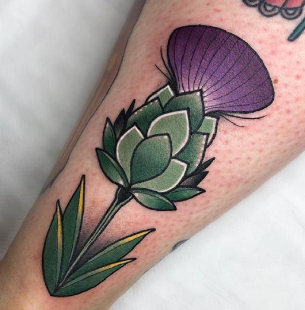 Traditional thistle tattoo on arm