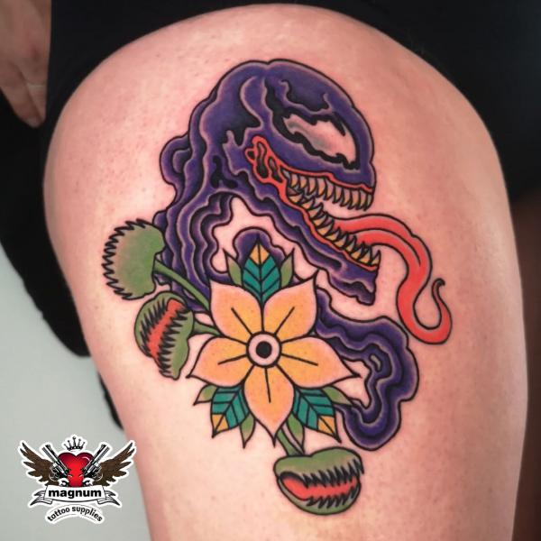 Traditional venom and flower tattoo