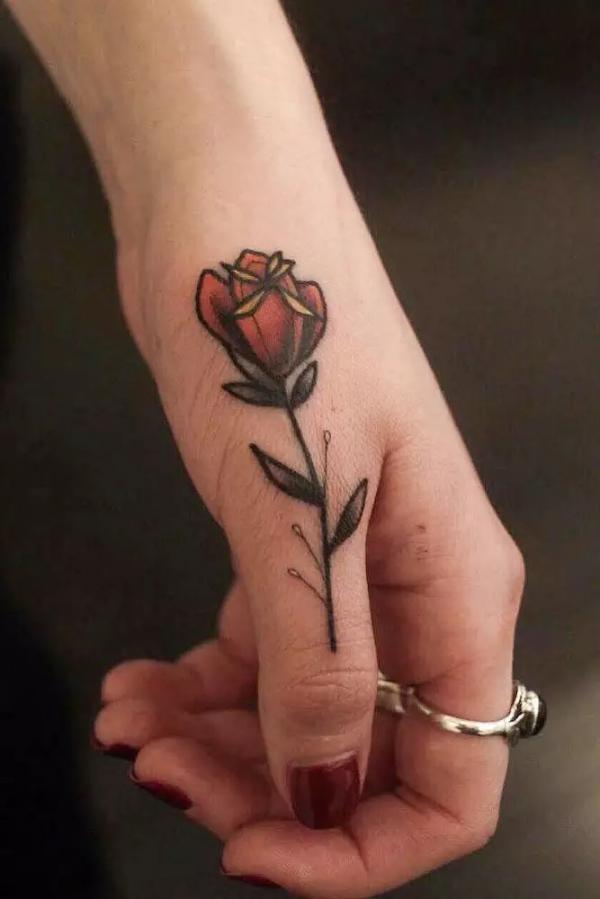 Traditional rose thenar web space tattoo