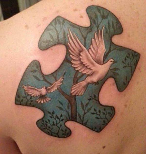 Tree puzzle and dove shoulder blade tattoo