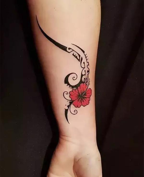 Tribal red hibiscus wrist tattoo