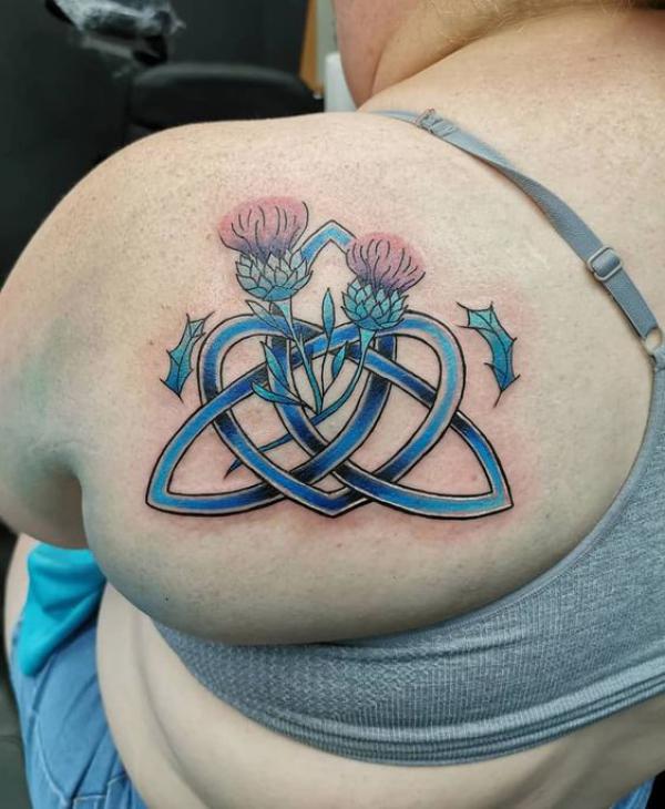Trinity knot and thistle shoulder blade tattoo