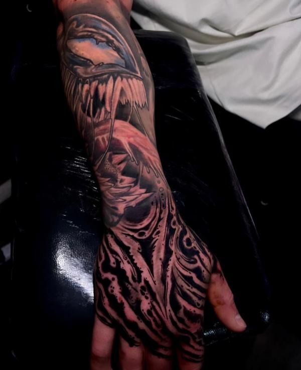Venom forearm and hand tattoo