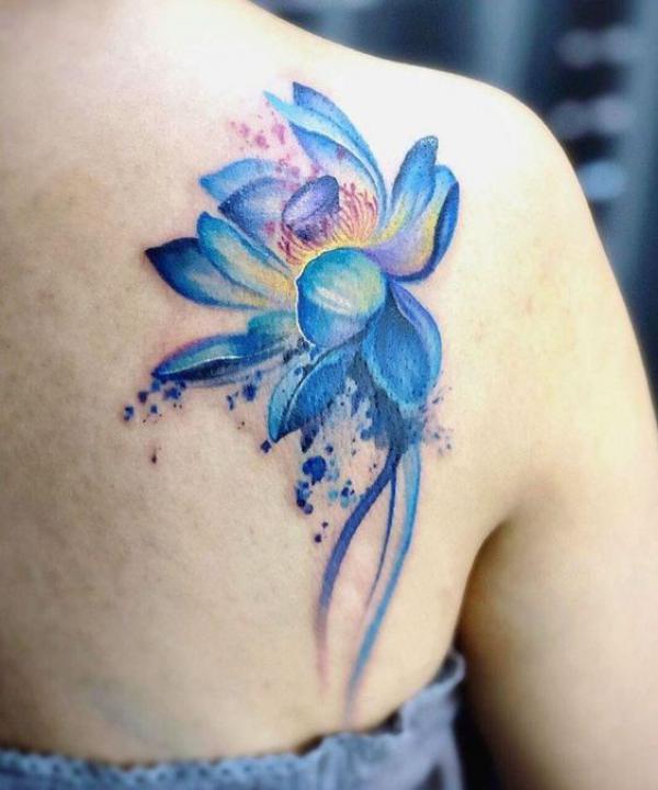 Watercolor blue lotus shoulder blade tattoo