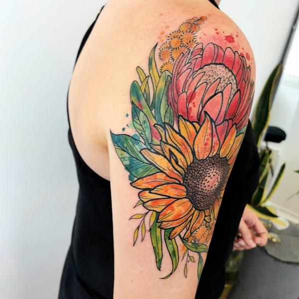 Watercolor protea and sunflower quarter sleeve tattoo