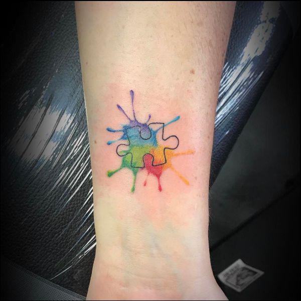 Watercolor puzzle wrist tattoo