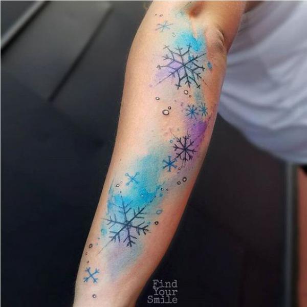 Watercolor snowflakes outer forearm tattoo