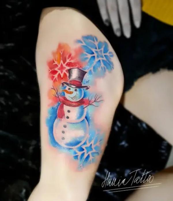Watercolor snowman and snowflake thigh tattoo