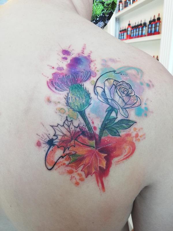 Watercolor thistle maple leaf and rose line work tattoo