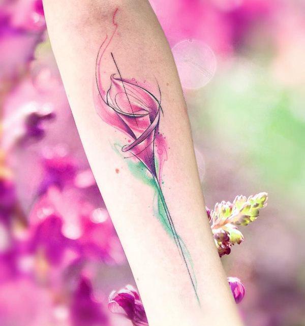 delicate watercolor calla lily tattoo on forearm