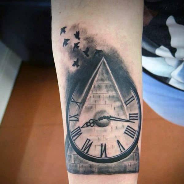 silhouette birds flying over pyramid with clock tattoo