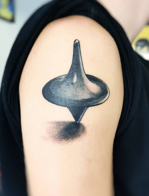 3D whirligig tattoo on the upper arm