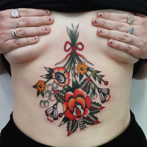 A bouquet of flowers sternum tattoo traditional