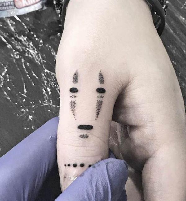 Abstract No Face finger tattoo