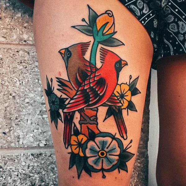 American traditional cardinal with flower thigh tattoo