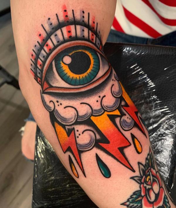 American traditional thunder eye tattoo on the side of elbow