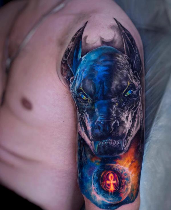 Anubis and Ankh tattoo on upper arm